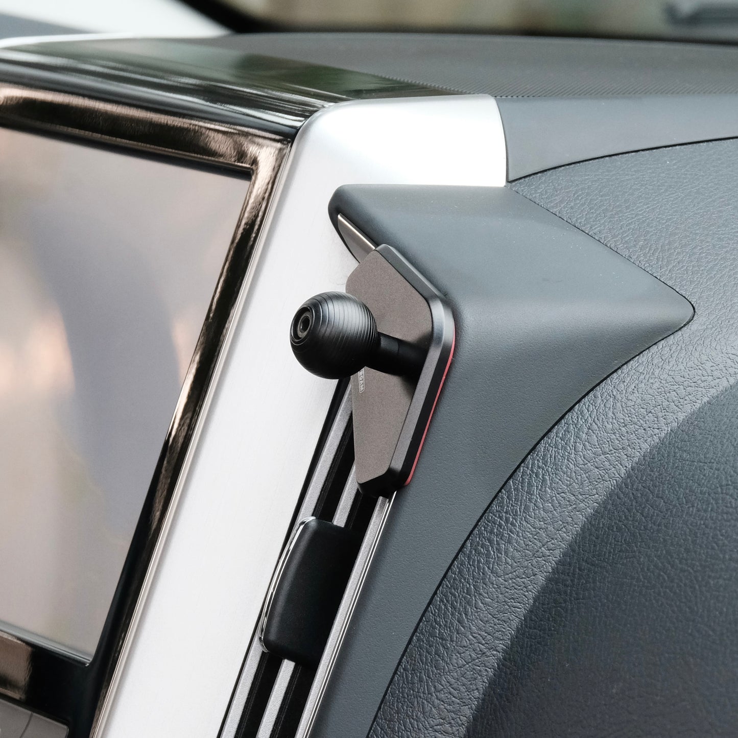 Image of Offroam Mounting Base installed securely in Toyota Land Cruiser 200 2016-2021. This premium all metal phone mounting base installs easily without drilling or glue. Perfect placement without blocking screens, driver view, or air flow.
