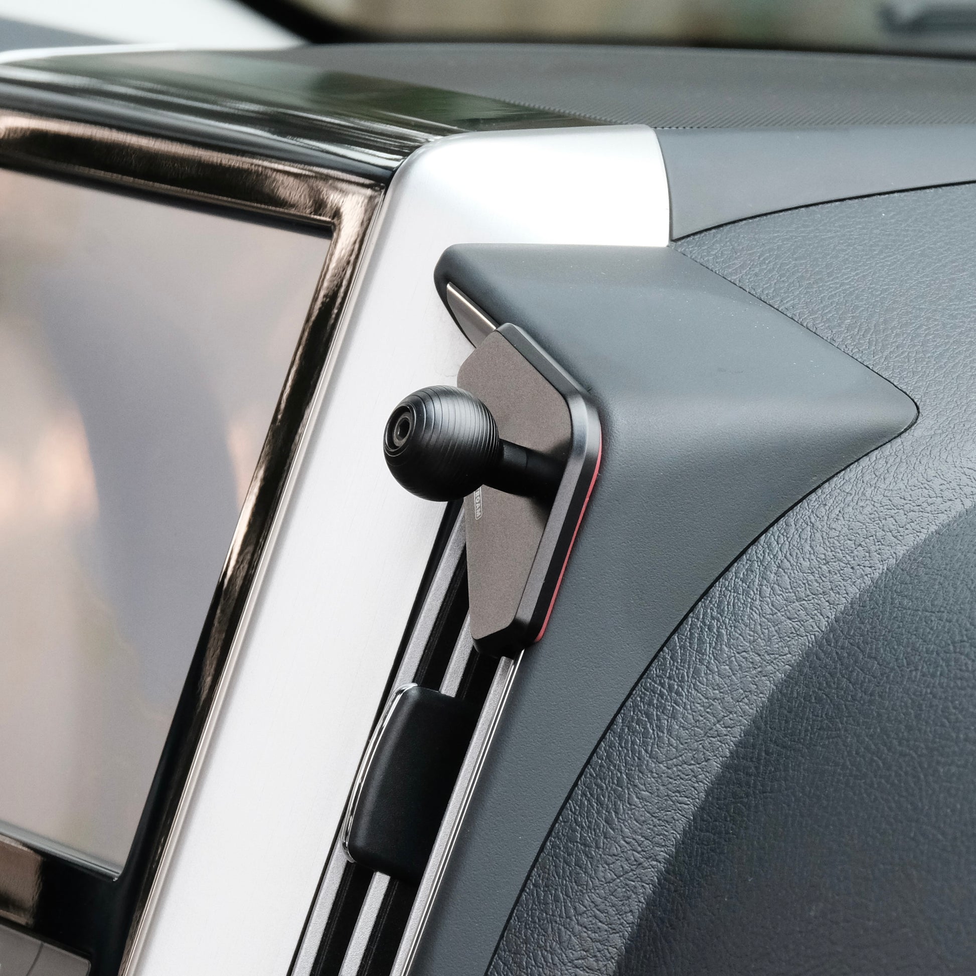 Image of Offroam Mounting Base installed securely in Toyota Land Cruiser 200 2016-2021. This premium all metal phone mounting base installs easily without drilling or glue. Perfect placement without blocking screens, driver view, or air flow.