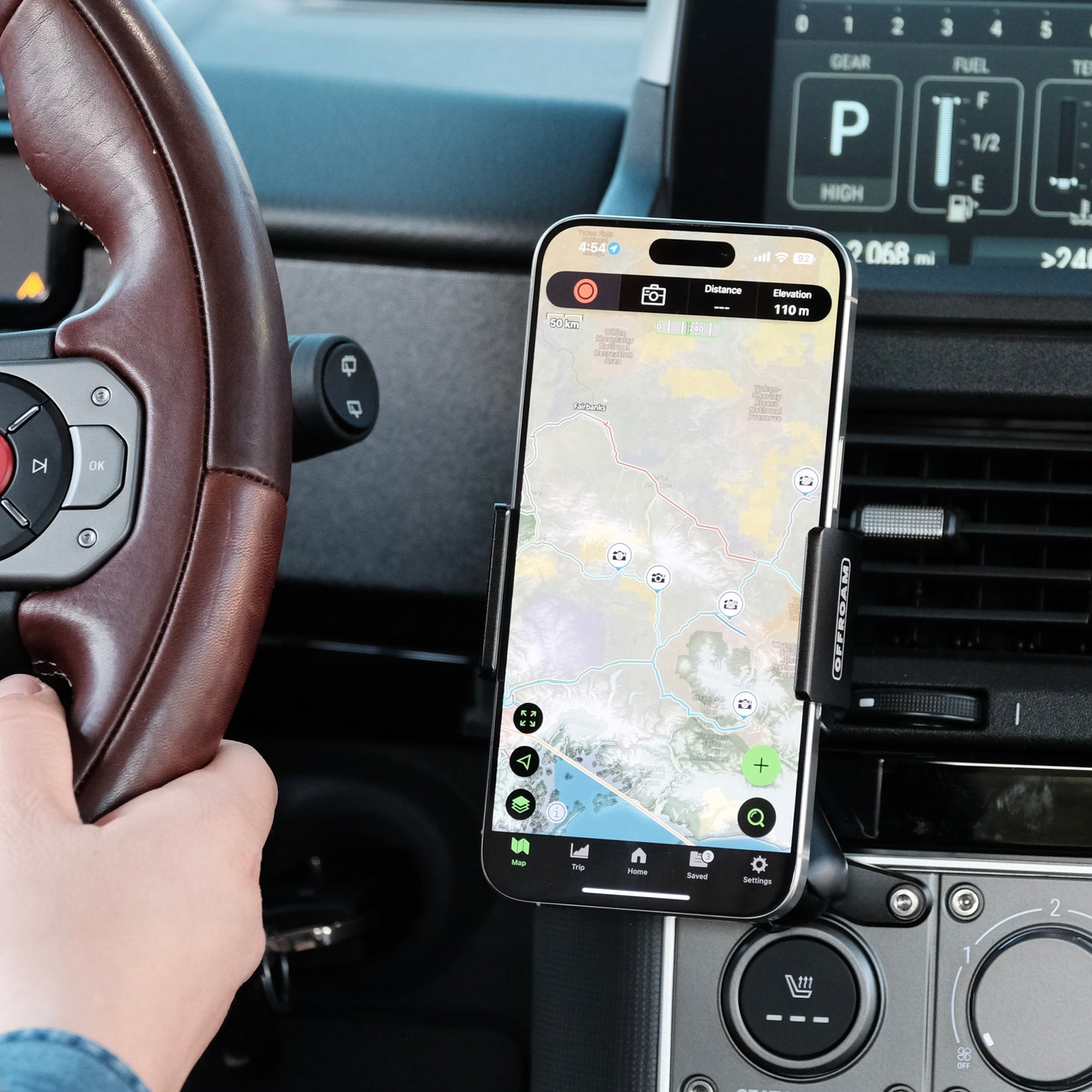 Image of Offroam Phone Mount installed securely in INEOS Grenadier 2022-2025. This premium phone mount installs easily without drilling or glue. Spring loaded Universal holder for use with any phone. Perfect placement without blocking screens, driver view, or air flow. Fully adjustable positioning.