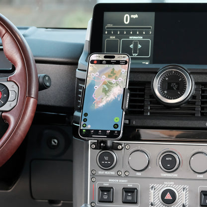 Image of Offroam Phone Mount installed securely in INEOS Grenadier 2022-2025. This premium phone mount installs easily without drilling or glue. Spring loaded Universal holder for use with any phone. Perfect placement without blocking screens, driver view, or air flow. Fully adjustable positioning.