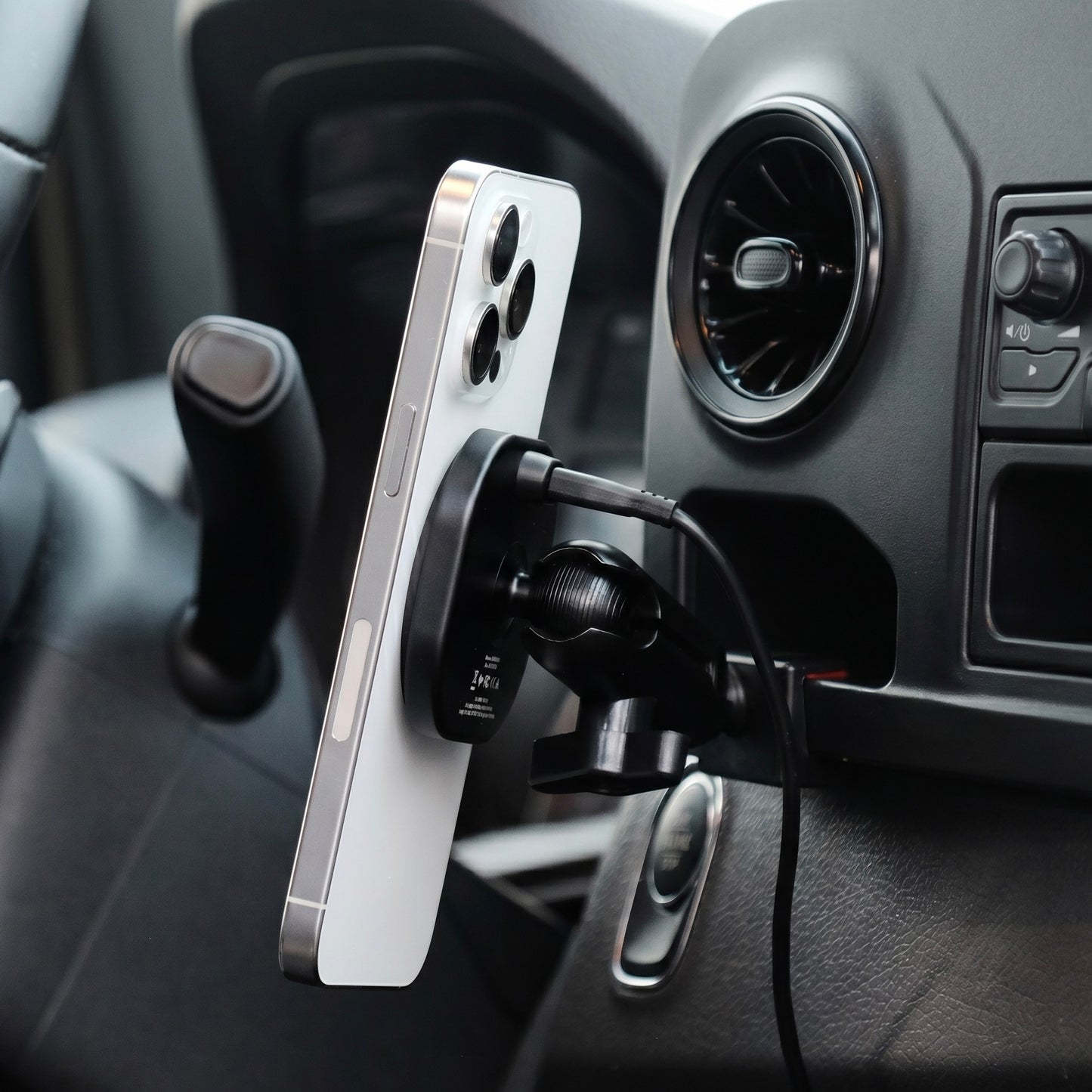 Image of Offroam MagSafe-compatible Phone Mount installed securely in Mercedes-Benz Sprinter 2019-2026. This premium phone mount installs easily without drilling or glue. High force magnets hold phone on any trail, road, or track. Perfect placement without blocking screens, driver view, or air flow. Fully adjustable positioning.