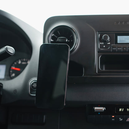 Image of Offroam MagSafe-compatible Phone Mount installed securely in Mercedes-Benz Sprinter 2019-2026. This premium phone mount installs easily without drilling or glue. High force magnets hold phone on any trail, road, or track. Perfect placement without blocking screens, driver view, or air flow. Fully adjustable positioning.