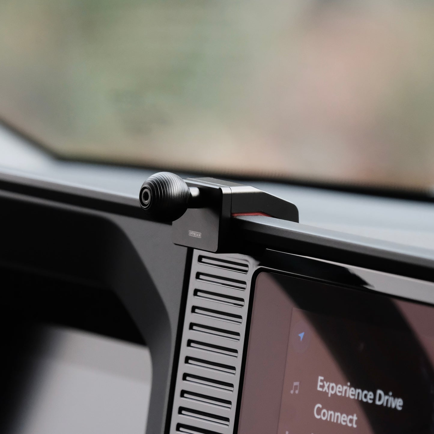 Image of Offroam Mounting Base installed securely in Toyota Land Cruiser Prado 250 2024-2025. This premium all metal phone mounting base installs easily without drilling or glue. Perfect placement without blocking screens, driver view, or air flow.