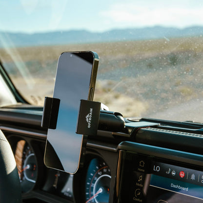 Secure all-metal off-road phone mount - a premium Jeep accessory - installed in a 2024-2025 Jeep Wrangler or Jeep Gladiator, holding a smartphone with a spring-loaded holder for optimal positioning during off-road exploration.